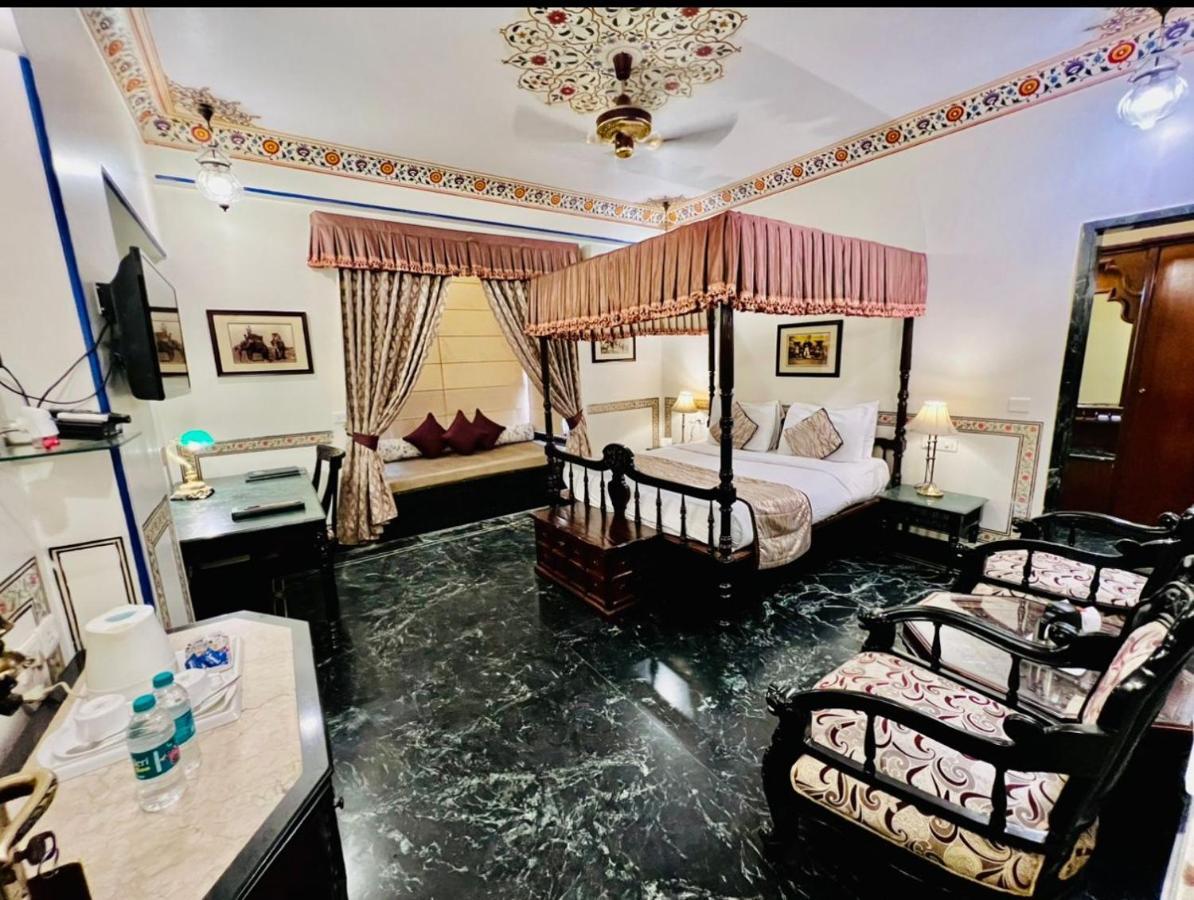 Royal Deluxe Room: Free pickup from train or bus station on arrival. Enjoy daily Rajasthani dance & music (7PM–9 PM), swimming pool, kids stay free, and a dedicated travel desk to assist with local sightseeing tours, intercity travel and activities