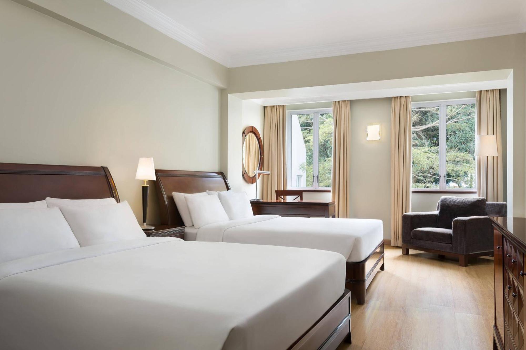 Deluxe Queen Room with Two Queen Beds and Pool View