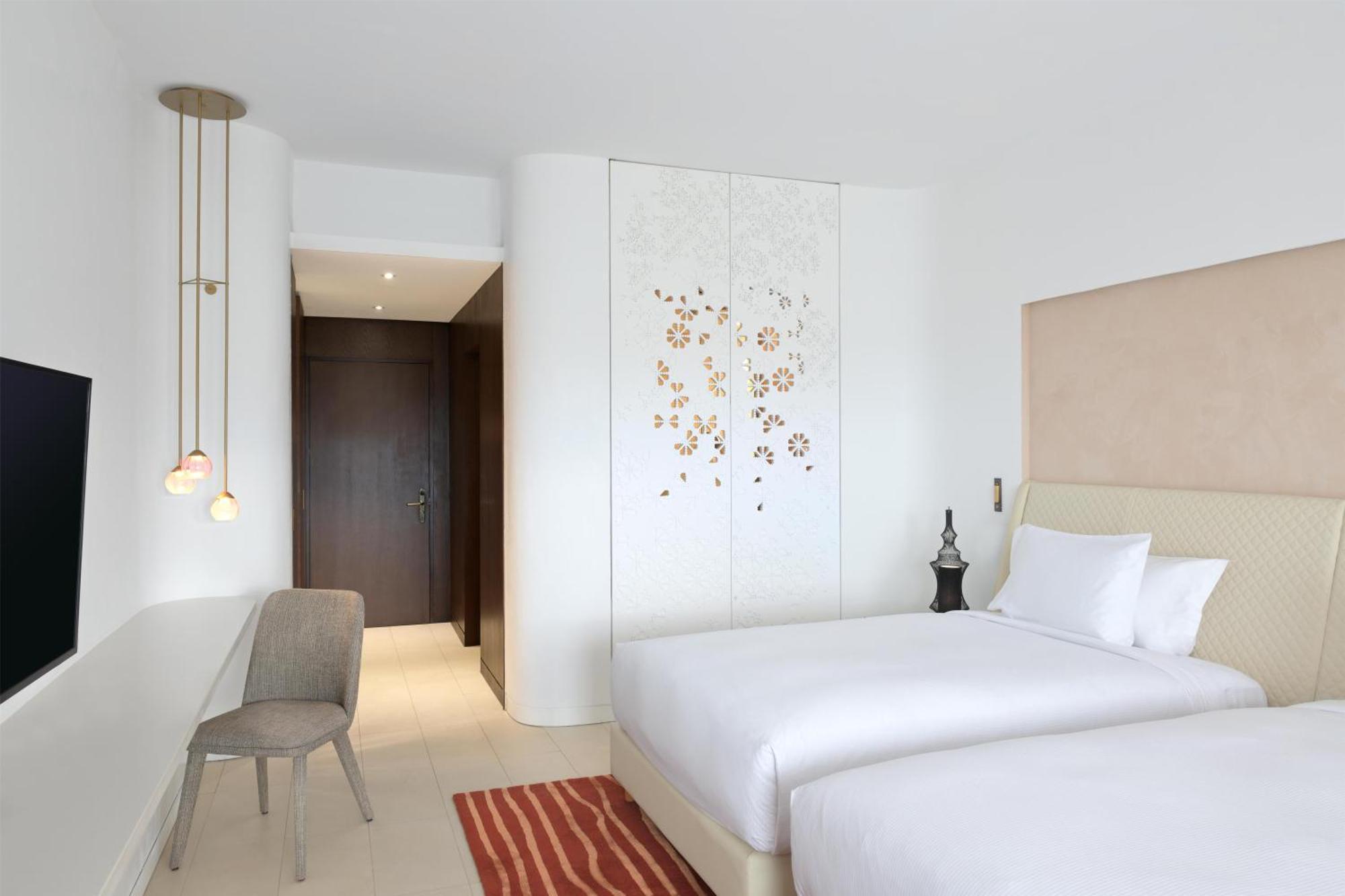 Guest Room with Two Double Beds and Partial Ocean View