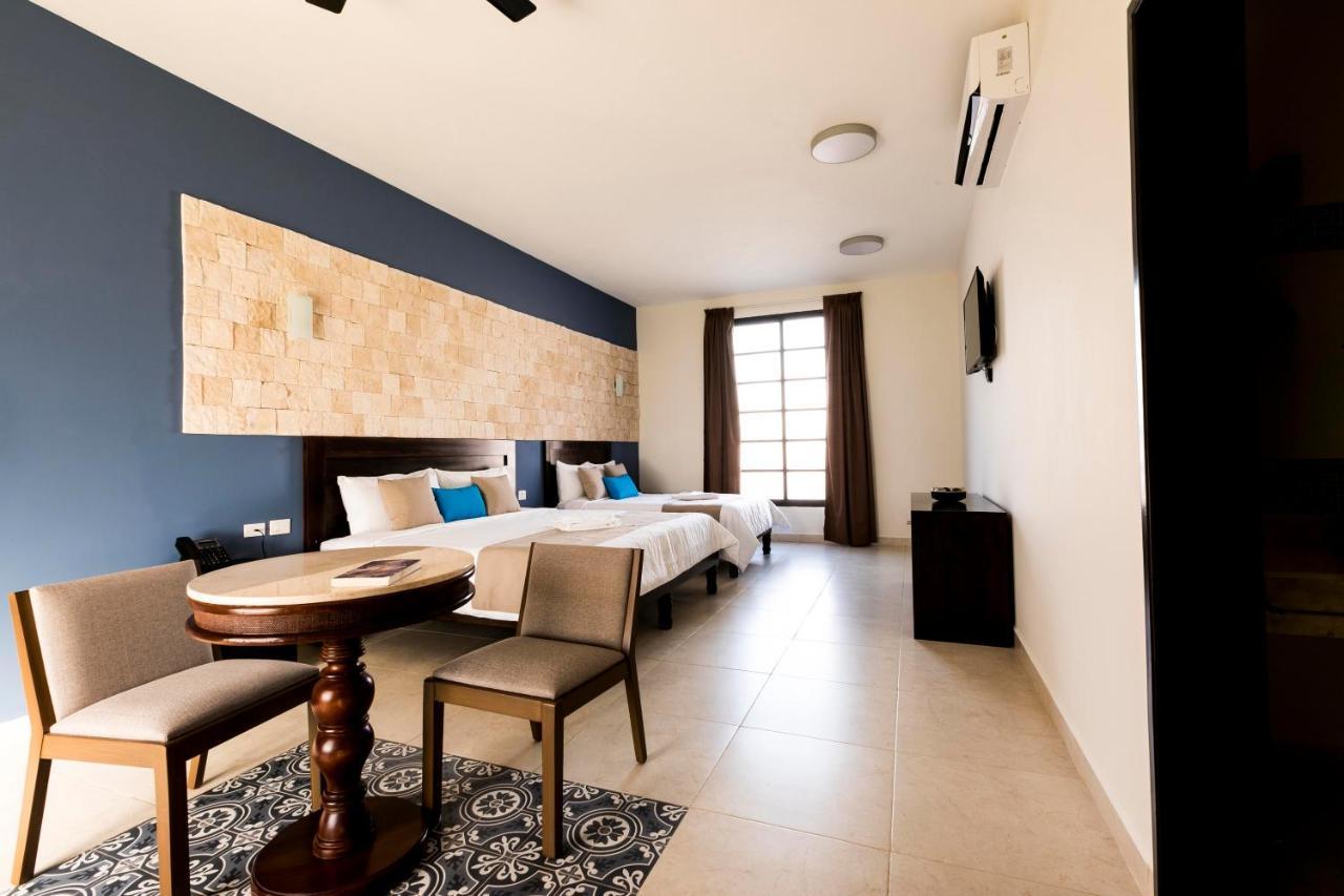 Junior Suite 1 king size bed and 1 double bed, living room, pool and garden view